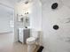 Modern bathroom featuring a sleek vanity, toilet, and a shower with marble-like tile and modern, matte black fixtures at 6508 Coral Cove Dr, Orlando, FL 32818