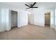 Light-filled bedroom featuring wood floors, closet, ceiling fan, and ensuite bath at 6508 Coral Cove Dr, Orlando, FL 32818