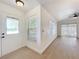 Inviting entryway with natural light, leading into a spacious living area with modern finishes at 6508 Coral Cove Dr, Orlando, FL 32818