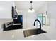 Well-lit kitchen with stainless steel sink, appliances, and modern countertops at 6508 Coral Cove Dr, Orlando, FL 32818