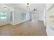 Bright living room with wood floors, modern lighting fixtures, and a kitchen view at 6508 Coral Cove Dr, Orlando, FL 32818