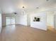 Inviting living room featuring wood floors, modern lighting, and access to the kitchen at 6508 Coral Cove Dr, Orlando, FL 32818