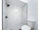 Shower with marble-like tile, black fixtures, and black and white tile flooring at 6508 Coral Cove Dr, Orlando, FL 32818