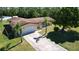 Aerial shot of single-story home with mature trees, long driveway and large, fenced yard at 717 Wedge Ln, Kissimmee, FL 34759