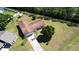 A high-angle view displaying the home with its driveway, manicured lawn, landscaping, and privacy fencing at 717 Wedge Ln, Kissimmee, FL 34759