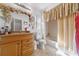 Well-lit bathroom features tile flooring, light walls, and a shower/tub combo at 717 Wedge Ln, Kissimmee, FL 34759