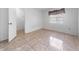 Bright bedroom features tile flooring, light walls, and a door leading to an additional room or closet at 717 Wedge Ln, Kissimmee, FL 34759