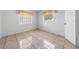 Bright bedroom features tile flooring, light walls, and two windows, creating a clean and airy space at 717 Wedge Ln, Kissimmee, FL 34759