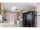Bright kitchen with white appliances, laminate countertops and wood cabinetry at 717 Wedge Ln, Kissimmee, FL 34759