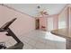 Open-concept living room with tile flooring, ceiling fan and sliding glass door at 717 Wedge Ln, Kissimmee, FL 34759