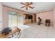Open-concept living room with tile floors and slider access to backyard at 717 Wedge Ln, Kissimmee, FL 34759