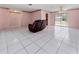 Open-concept living room with tile flooring, light walls, and a comfortable leather sofa at 717 Wedge Ln, Kissimmee, FL 34759