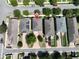 An aerial view shows the house with neutral tones, a driveway, a small yard and mature trees at 8016 Sweet Orange Ave, Winter Garden, FL 34787