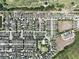 Aerial of a residential area situated near a lush golf course; community seamlessly blends nature with modern living at 8016 Sweet Orange Ave, Winter Garden, FL 34787