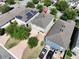 An aerial view shows the house with neutral tones, a driveway, a small yard and mature trees at 8016 Sweet Orange Ave, Winter Garden, FL 34787