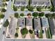Aerial view of the townhome featuring a brick paved driveway and solar panels in a well maintained community at 8016 Sweet Orange Ave, Winter Garden, FL 34787