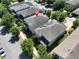 An aerial view of a well-maintained two-story home with a neutral exterior and a gray roof amidst lush landscaping at 8016 Sweet Orange Ave, Winter Garden, FL 34787