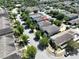 An aerial view shows the house with neutral tones, a driveway, a small yard and mature trees at 8016 Sweet Orange Ave, Winter Garden, FL 34787
