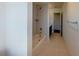 The bright, neutral-toned bathroom features tile flooring and a soaking tub with a built-in shower and chrome fixtures at 8016 Sweet Orange Ave, Winter Garden, FL 34787