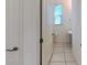 Powder room with tile flooring, sink, and window at 8016 Sweet Orange Ave, Winter Garden, FL 34787