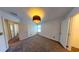 Bedroom features a pendant light, neutral carpeting, and natural light from a window at 8016 Sweet Orange Ave, Winter Garden, FL 34787
