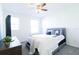 Bright bedroom features a plush bed, soft carpet, and a ceiling fan for added comfort at 8016 Sweet Orange Ave, Winter Garden, FL 34787