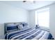 A bright bedroom boasts neutral walls, carpet, a window seat and a large window to let the light stream in at 8016 Sweet Orange Ave, Winter Garden, FL 34787