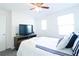 Bright bedroom features a plush bed, soft carpet, and a ceiling fan for added comfort at 8016 Sweet Orange Ave, Winter Garden, FL 34787