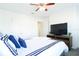 Bright bedroom features a plush bed, soft carpet, and a ceiling fan for added comfort at 8016 Sweet Orange Ave, Winter Garden, FL 34787