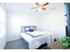 Bright bedroom features a plush bed, soft carpet, and a ceiling fan for added comfort at 8016 Sweet Orange Ave, Winter Garden, FL 34787