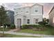 Stylish two-story home with manicured landscaping, offering a welcoming front entrance and a modern design at 8016 Sweet Orange Ave, Winter Garden, FL 34787
