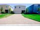 A contemporary home with a two-car garage, featuring a spacious driveway and well-maintained front yard at 8016 Sweet Orange Ave, Winter Garden, FL 34787