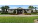 Community center with a beautiful yard, trees, and flowerbeds adding a burst of color to the entrance at 8016 Sweet Orange Ave, Winter Garden, FL 34787