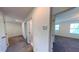 Bright hallway with white walls and neutral carpeting provides access to multiple rooms at 8016 Sweet Orange Ave, Winter Garden, FL 34787