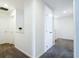 Bright hallway with white walls and neutral carpeting provides access to multiple rooms at 8016 Sweet Orange Ave, Winter Garden, FL 34787