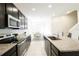 Open kitchen layout with stainless steel appliances, granite countertops, and easy access to the dining area at 8016 Sweet Orange Ave, Winter Garden, FL 34787