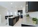 Modern kitchen with granite countertops, stainless steel appliances, sleek black cabinetry and island with seating at 8016 Sweet Orange Ave, Winter Garden, FL 34787