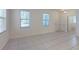 Open concept living area with natural light, tile flooring, and access to a full bathroom at 8016 Sweet Orange Ave, Winter Garden, FL 34787
