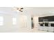 Bright, open concept living area with tile flooring, kitchen, and access to entry doors and closets at 8016 Sweet Orange Ave, Winter Garden, FL 34787
