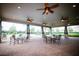 Spacious outdoor patio with brick pavers, ceiling fans, tables and chairs offering a relaxing gathering space at 8016 Sweet Orange Ave, Winter Garden, FL 34787