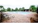 Community pool with lounge chairs surrounded by lush landscaping, offering a relaxing retreat at 8016 Sweet Orange Ave, Winter Garden, FL 34787