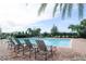 Community pool with lounge chairs surrounded by lush landscaping, offering a relaxing retreat at 8016 Sweet Orange Ave, Winter Garden, FL 34787