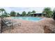 Community pool with lounge chairs surrounded by lush landscaping, offering a relaxing retreat at 8016 Sweet Orange Ave, Winter Garden, FL 34787
