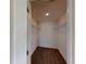 A walk-in closet features neutral walls and carpet, a ceiling light fixture and chrome shelving for storage at 8016 Sweet Orange Ave, Winter Garden, FL 34787