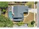 Aerial view showcases the house with a pool, roof, landscaping and surrounding neighborhood at 8603 Black Creek Blvd, Orlando, FL 32829