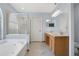 Bathroom featuring a glass enclosed shower, a soaking tub, double sink vanity, and tile flooring at 8603 Black Creek Blvd, Orlando, FL 32829