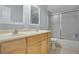 Bathroom with double sink vanity with framed mirrors, tile flooring and a shower with sliding glass doors at 8603 Black Creek Blvd, Orlando, FL 32829