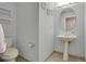 Bathroom features a pedestal sink, toilet and painted light blue walls at 8603 Black Creek Blvd, Orlando, FL 32829
