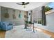 Music room featuring hardwood floors, a ceiling fan, and multiple guitars hanging on a gray, wooden accent wall at 8603 Black Creek Blvd, Orlando, FL 32829