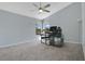 Bedroom with vaulted ceiling, carpet flooring and a modern glass desk with computer at 8603 Black Creek Blvd, Orlando, FL 32829